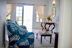 a living room with a couch and a table at Castles in Paradise 1bd Apt C6 by ZenBreak in Rouarné