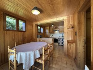 a kitchen with a table and chairs in a room at Chalet du Grand Arbre in Le Ménil