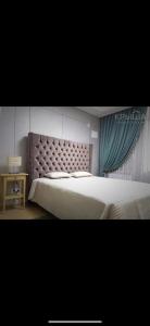 a bedroom with a large bed and a side table at Korkem in Zhezdi