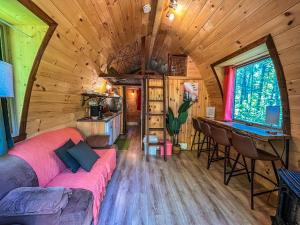 a living room and kitchen in a tree house at Exode en Nature in Sainte-Rose-du-Nord