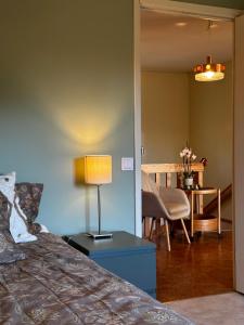a bedroom with a bed and a table with a lamp at Företags- eller semesterboende Sjöutsikten in Gällivare