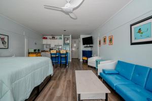 a bedroom with a bed and a blue couch at Park Place Unit 129 in Cedar Key