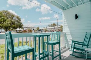 two chairs and a table on a porch with a view of the beach at Park Place Unit 129 in Cedar Key