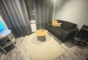 a living room with a couch and a table at Zlatá Víla by Cañas Apartments V srdci mesta, len pár krokov od hlavného námestia in Rimavská Sobota