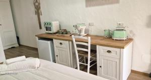 a kitchen with a counter with appliances on it at Imperyal case vacanze Sud Sardegna in Giba