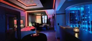 a living room with a red couch and a mirror at Pause Thermale Suite in Herstal