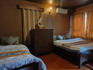 Un dormitorio con dos camas y una cómoda. en Nepal Blissful Nest And Family Home, en Katmandú 6 fotos más
