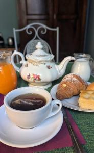 a table with a cup of coffee and a plate of food at La magia del mare in Sanremo