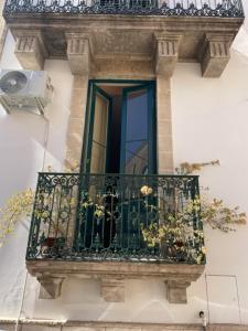 a balcony with a window with flowers on it at Casa Mari in Manduria