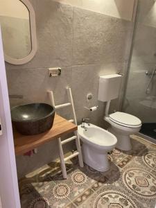 a bathroom with a sink and a toilet at Casa Mari in Manduria +2 photos