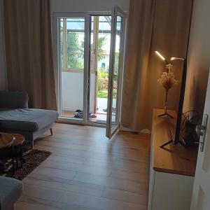 a living room with a door open to a patio at Apartman Andrić in Lovran +4 photos