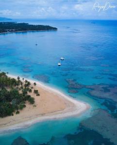 an aerial view of a beach with a boat in the water at Modern apartament near the sea-Las Terrenas in La Iglesia