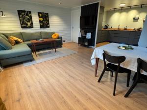 a living room with a couch and a table at Solheim Apartment in Senja