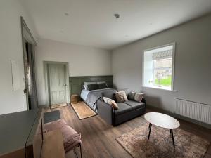 a living room with a couch and a table at Crossdrum Courtyard Accommodation in Oldcastle