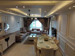 a living room with a couch and a table at Dar Residence - Madinaty B12 - U1 - 3 BR - New Cairo in Madinaty