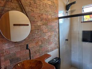 a bathroom with a wooden sink and a brick wall at Recanto Cachoeiras de Ibicoara in Ibicoara +29 photos