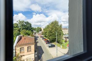 a view of a city street from a window at 1-bedroom loft in Siena Tirgus in Rīga
