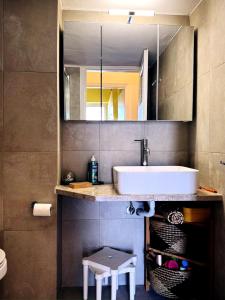 a bathroom with a sink and a mirror at Pinetree House in Nafplio
