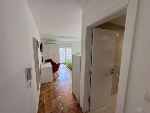 a hallway with a door to a kitchen and a room at Julija 4 in Pančevo