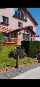 a large house with a fence in front of it at Hotel Koi Mahik in El Calafate