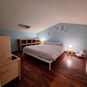 a bedroom with a bed and a blue wall at La coccinella in Castelfiorentino