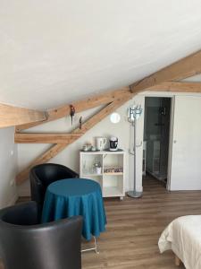 a bedroom with a blue table in a room at Les Voutes de Villebourbon in Montauban