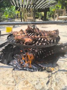 a grill with some meat on top of it at Mpole Bungalows in Michamvi