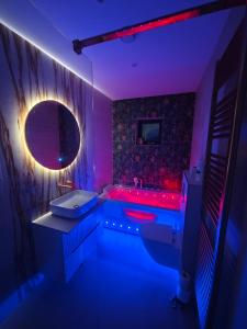 a purple bathroom with a tub and a sink at Galway Paradisus in Galway