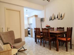 a kitchen and dining room with a table and chairs at Akrata Maisonette in Akrata