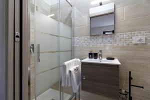 a bathroom with a shower and a sink and a mirror at Sonia Holiday Home - Camera Susan in Pont-Saint-Martin