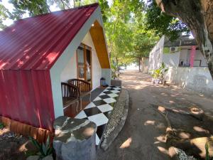 a small house with a red roof and a checkered floor at Kabin Sahara in Pulau Tidung-kecil