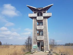 a tall building with balconies on it in a field at Rentumi Hostel Gryfino-Noclegi Turystyczne i Pracownicze in Gryfino +16 photos
