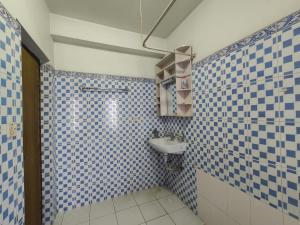 a blue and white tiled bathroom with a sink at Peace Home Apartment Swayambhu in Kathmandu +37 photos