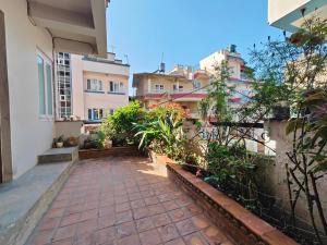 a courtyard of a building with plants and buildings at Peace Home Apartment Swayambhu in Kathmandu