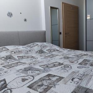 a bed with a patterned blanket on top of it at ForRest spa in Ravna Gora +19 photos