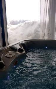 a jacuzzi tub with snow in a room at ForRest spa in Ravna Gora