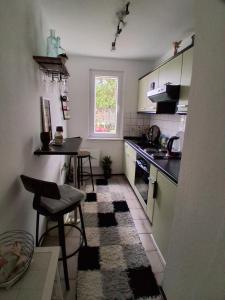 a small kitchen with a table and a counter at Seenahe Wohnung in Nordhausen