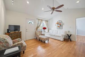 a living room with a white couch and a ceiling fan at 3BR Nature Retreat Near Lake James and Morganton in Morganton