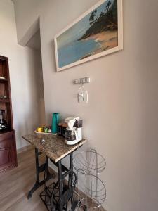a kitchen with a table with a coffee maker on it at Sweet House Búzios in Búzios