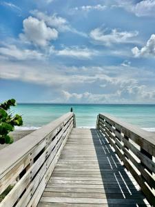 a wooden boardwalk leading to the beach at PoshPadz Pool Villa, Hot Tub, Near Beach, Sleeps 6 in Jupiter