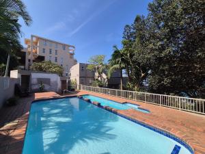 a swimming pool in the middle of a building at 101 Camarque - 3 Bedroom Beachfront Apartment In Umdloti - 180 Degree Sea Views in Umdloti