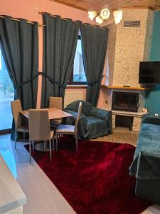 a living room with a table and a couch at Tokastro2 in Arachova +5 photos