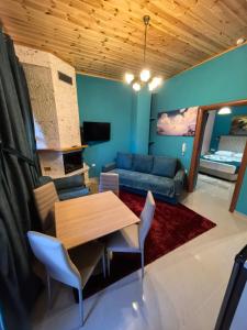 a living room with a table and a couch at Tokastro2 in Arachova