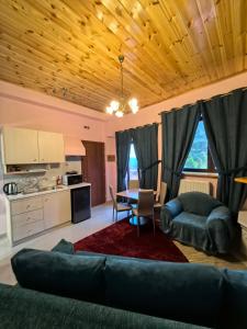 a living room with a couch and a table at Tokastro2 in Arachova