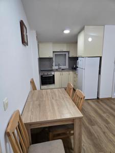 a kitchen with a table and chairs and a refrigerator at Azar in Bar