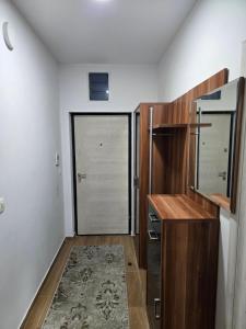 a kitchen with a wooden cabinet and a door at Azar in Bar +7 photos