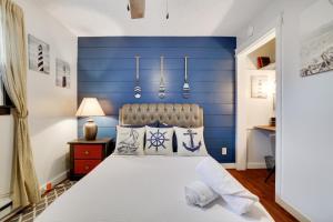 a bedroom with a blue accent wall and a bed at Pocono - Home away from home in Tobyhanna