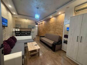 a living room with a couch and a table at Apartman Martina 3 in Rafailovici