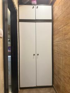 a closet with white cabinets and a mirror at Apartman Martina 3 in Rafailovici