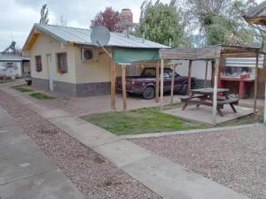 a picnic table and a car parked in front of a house at BelloLugar in San Rafael